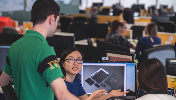A diverse team collaborating over product samples and industry catalogs.