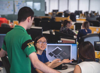 A diverse team collaborating over product samples and industry catalogs.