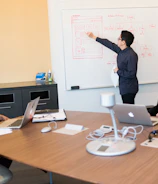 Project managers reviewing schedules and progress charts in a meeting.