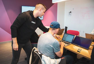 A focused engineering team collaborating over technical blueprints in a modern workspace.