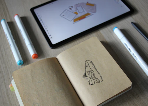 Industrial designers sketching product concepts on digital tablets.