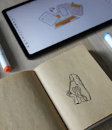 Industrial designers sketching product concepts on digital tablets.